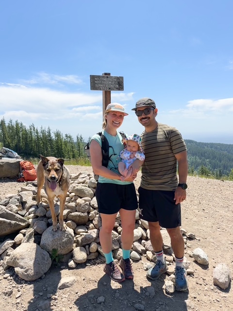 Photo of Jen, her husband, and their baby.